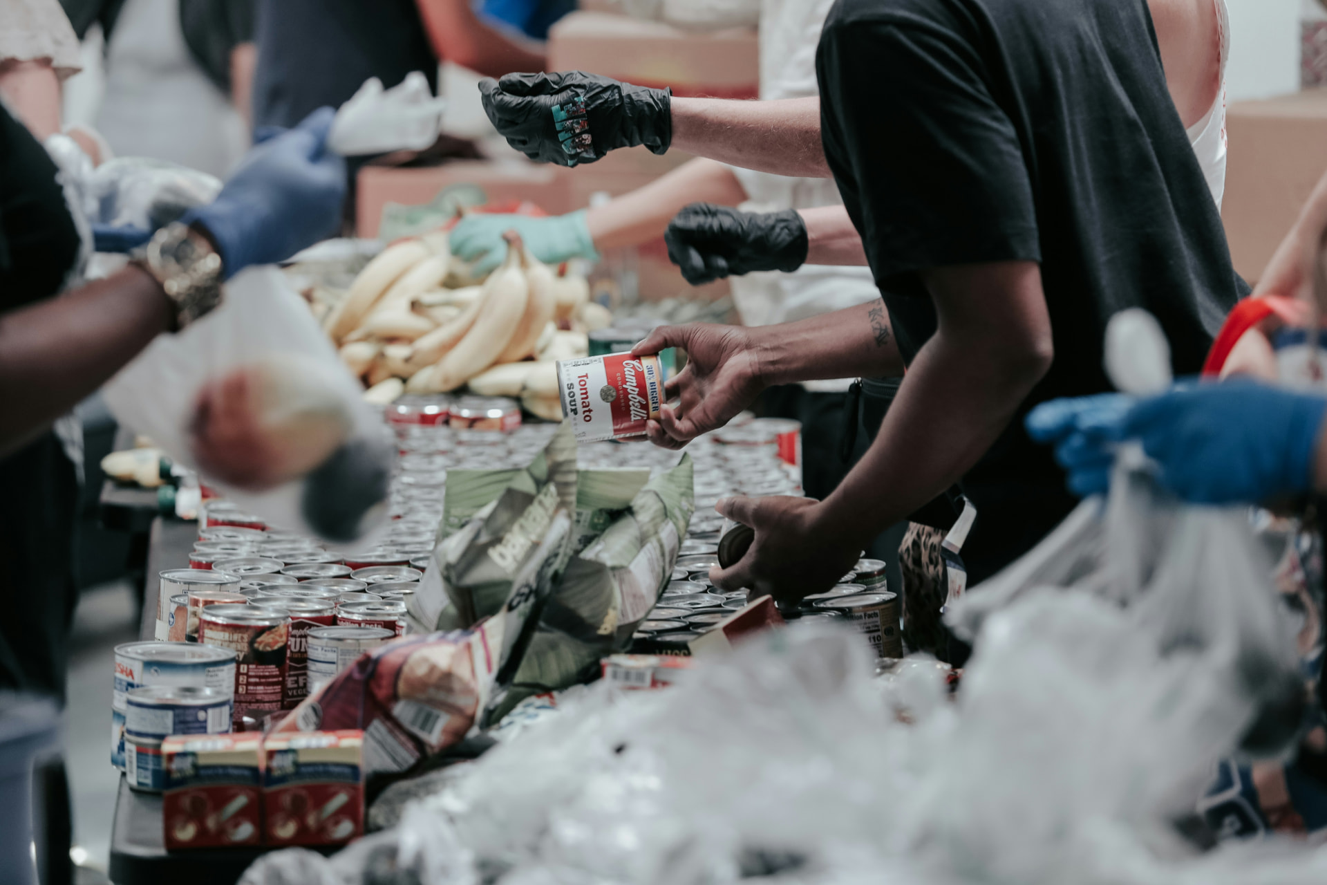 Volunteers packing bags of donated food at a community food bank