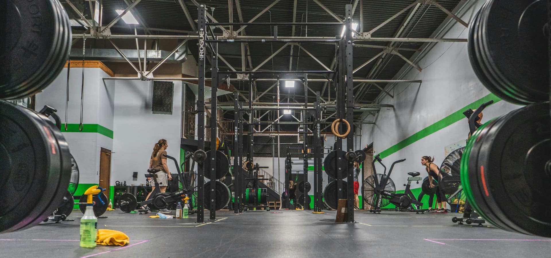 Squat rack and weight plates inside a Calgary strength and conditioning facility