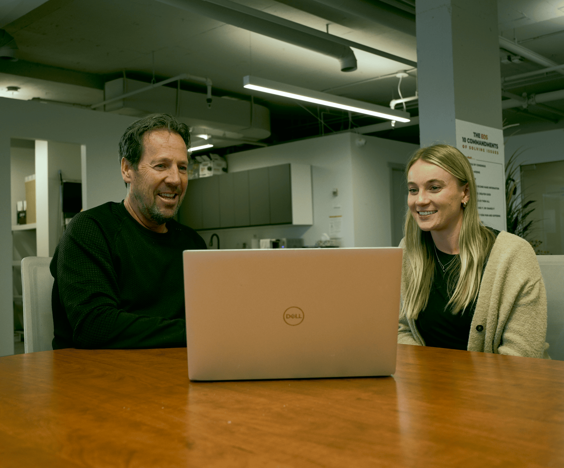 LAN advisor and client looking at a laptop together